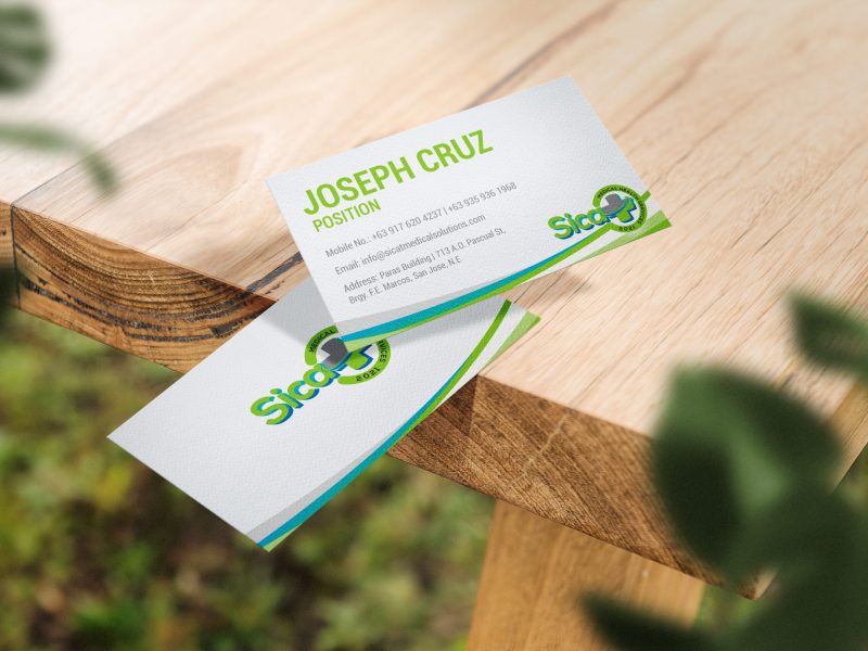 Clean minimal business card mockup floating on top table with leaves background. PSD file.